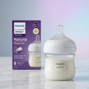 Philips Avent Natural Response 125ml clear baby bottle next to purple packaging.