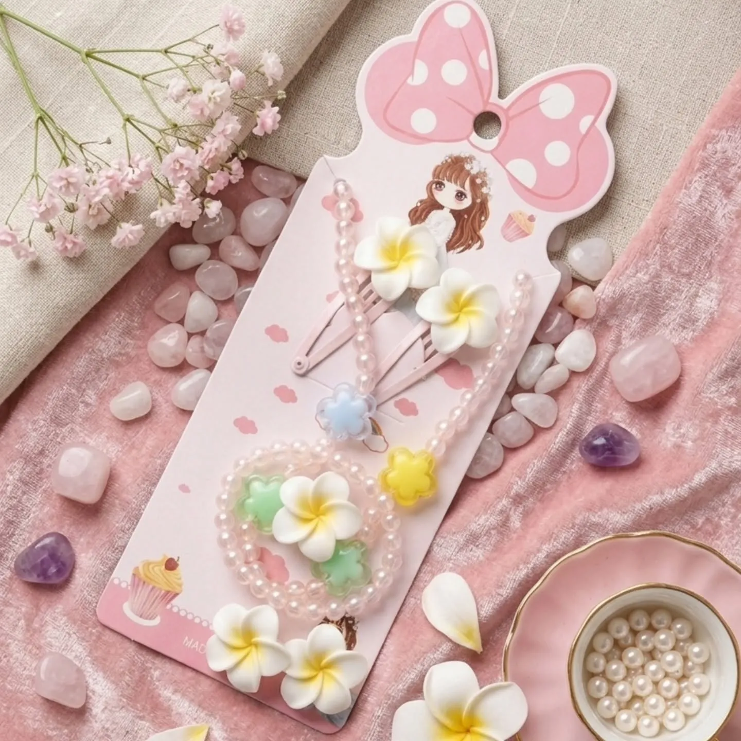 Kids pink pearl necklace bracelet set with white plumeria flower clips on presentation card.