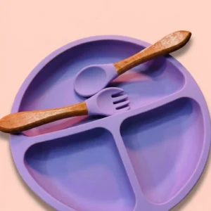 Pastel purple silicone divided baby suction plate with matching wooden handle spoon and fork.