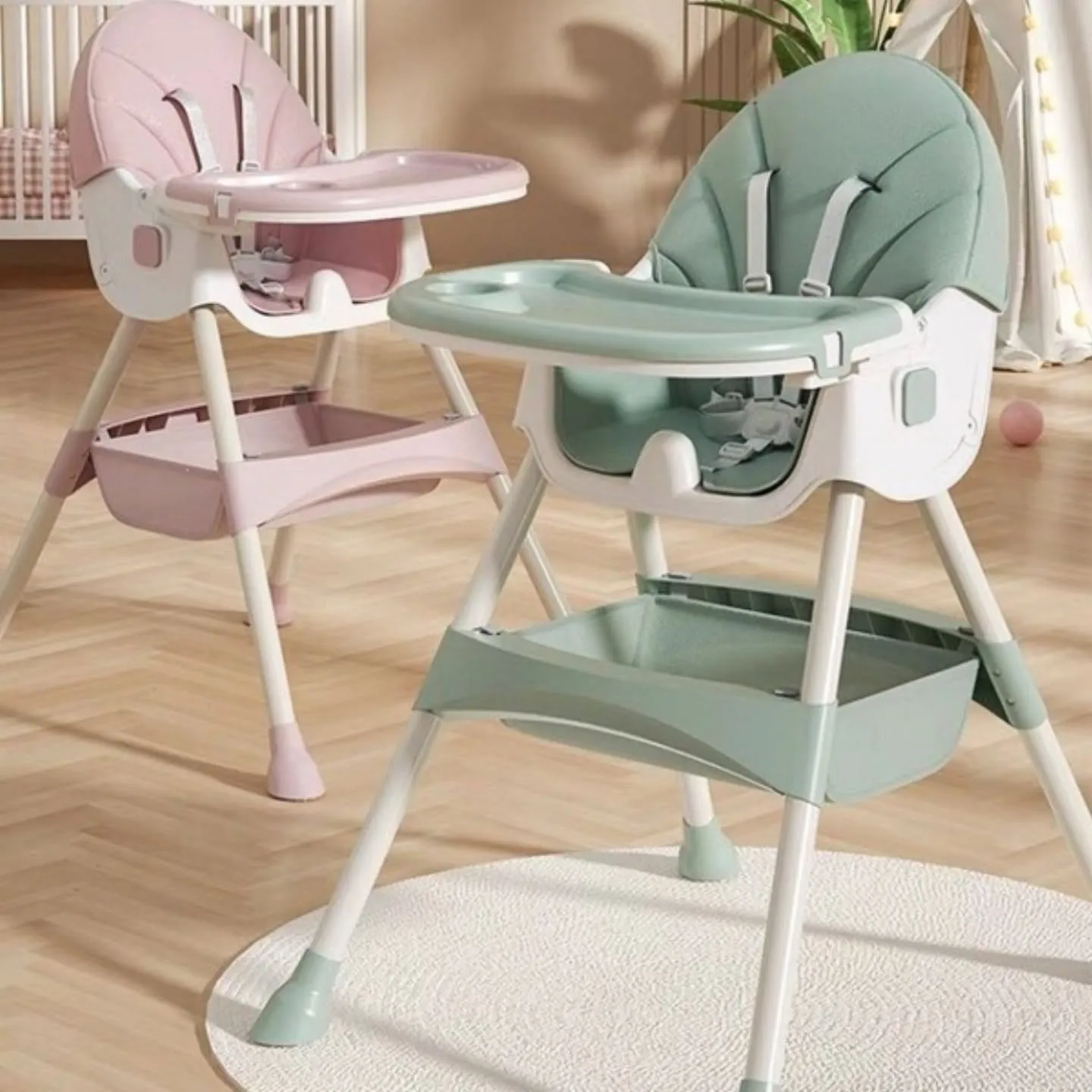 Sage green adjustable baby high chair with tray folded back and lockable wheels.
