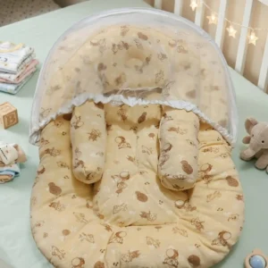 Beige printed baby nest bed inside a wooden crib with umbrella-style raised mosquito net and pillows.