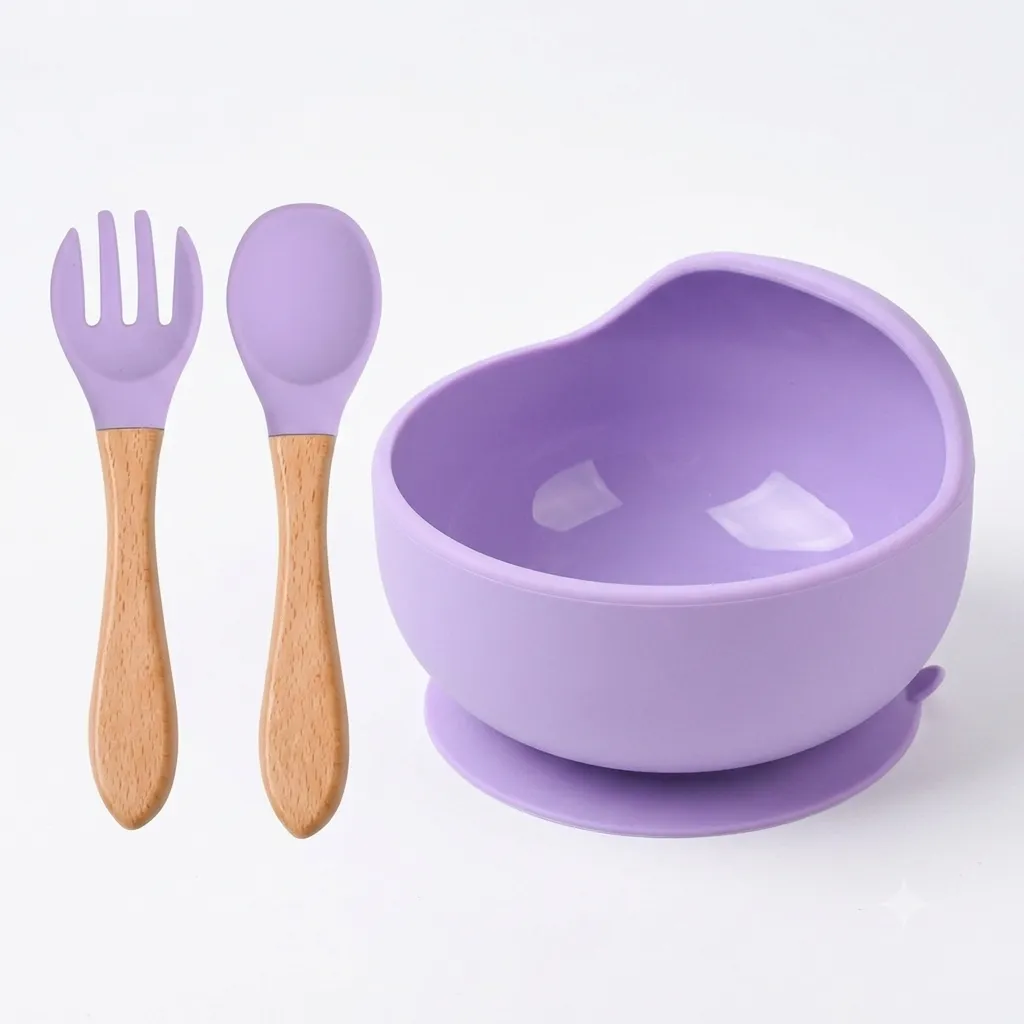 Pastel purple silicone baby suction bowl with matching wooden handle spoon and fork.