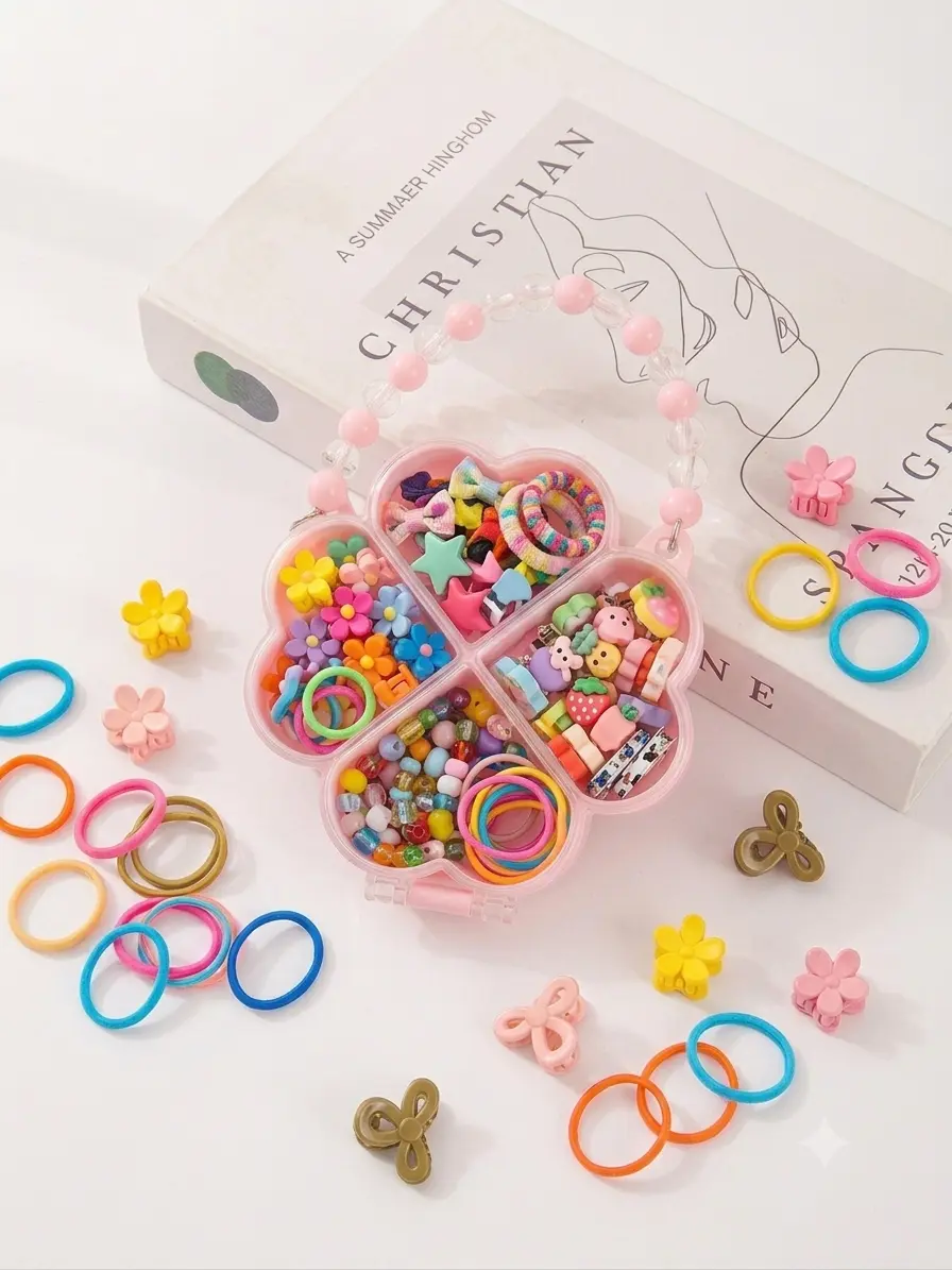 Four leaf clover shaped pink acrylic hair accessories storage box with beaded handle containing hair bands and mini claw clips.