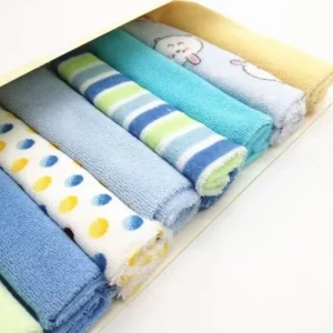 Close up of colorful rolled soft baby washcloths showing polka dots and stripes.
