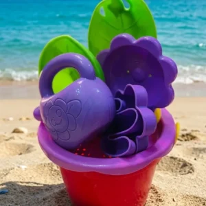 Kids colorful beach bucket and sand toy set with shovels and molds packaged in a net mesh bag.