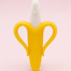 Yellow baby banana silicone teether and training toothbrush with soft silicone bristles held by a smiling baby.