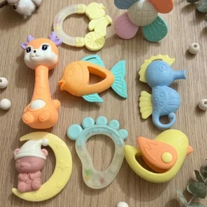 8-piece colorful baby rattles and food-grade silicone teether set arranged on a wooden background.